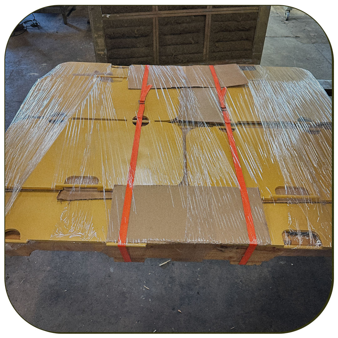 Photo of fabricated metal painted yellow wrapped in clear plastic wrap